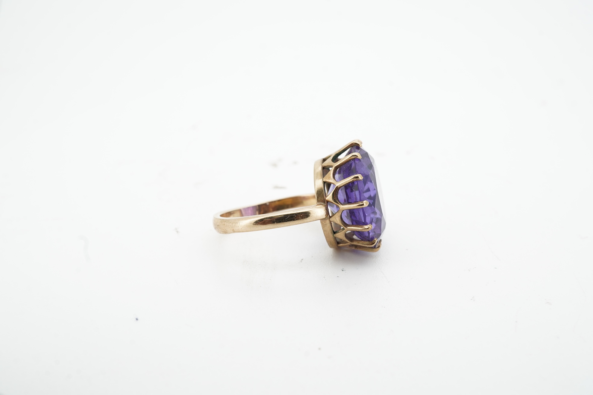 A synthetic colour-change sapphire ring, claw-set with a circular-cut synthetic colour-change sapphire measuring approximately 15 x 15 x 7.9mm, mounted in gold, size H1/2